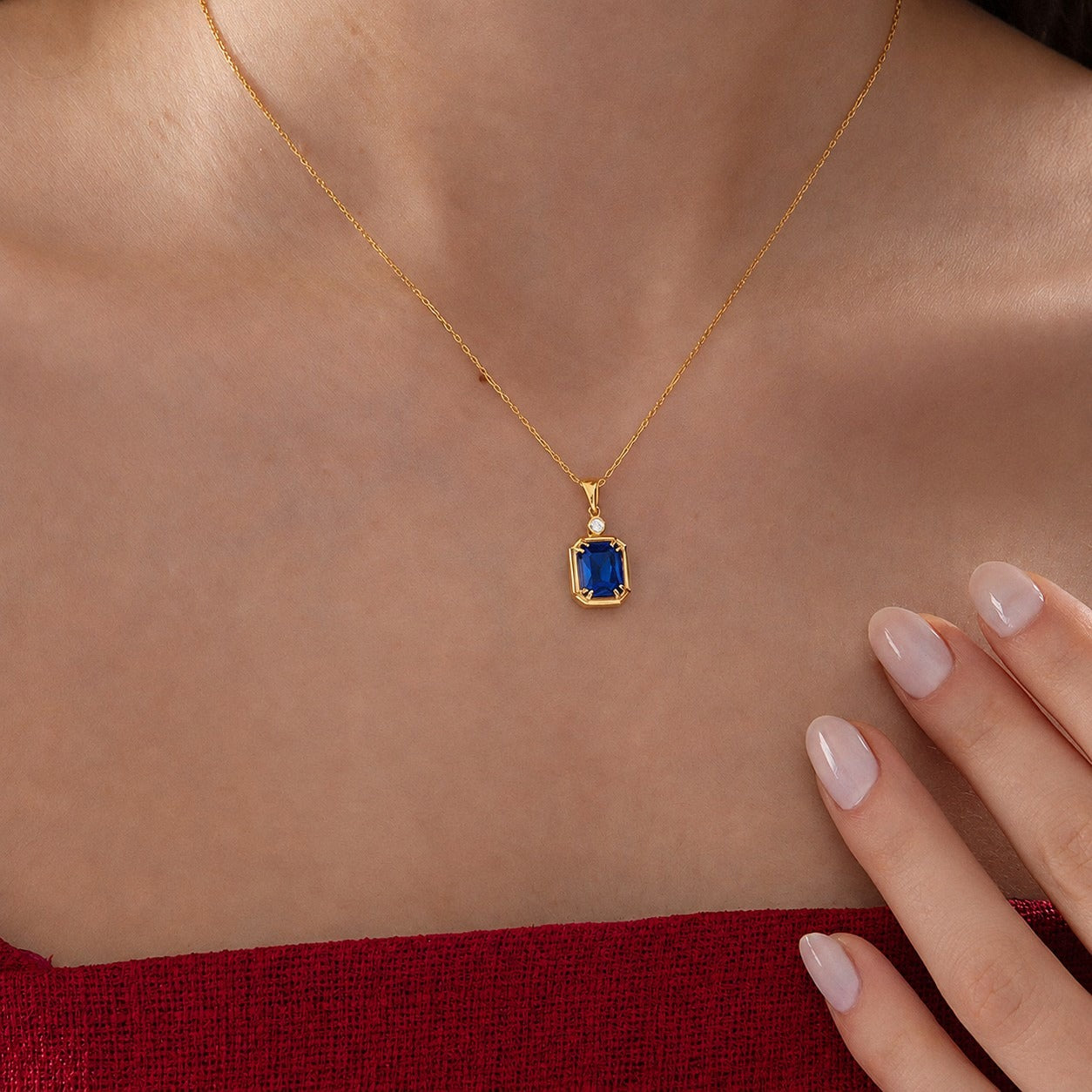 Emerald Cut Sapphire Necklace with Diamond in gold, worn