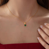 Heart Emerald Necklace with Diamond Swirl in gold, worn