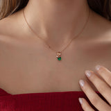 Heart Emerald Necklace with Diamond Swirl in rose gold, worn