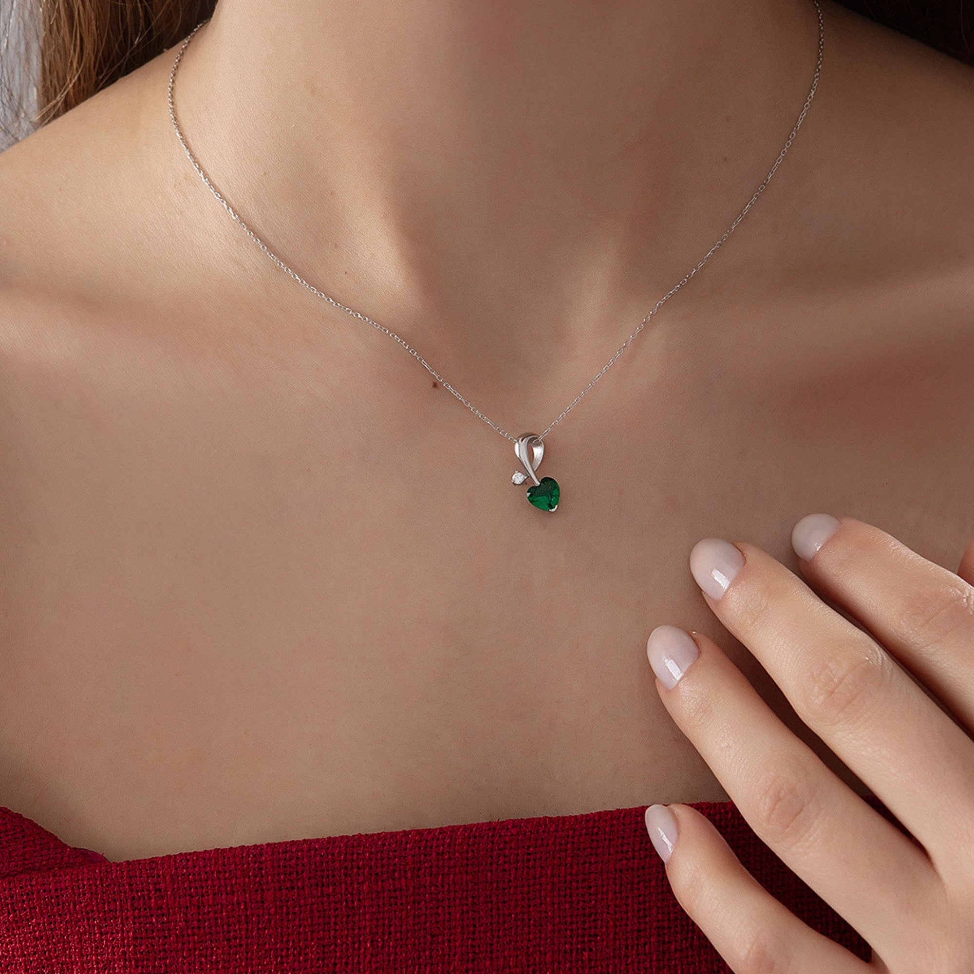 Heart Emerald Necklace with Diamond Swirl in silver, worn