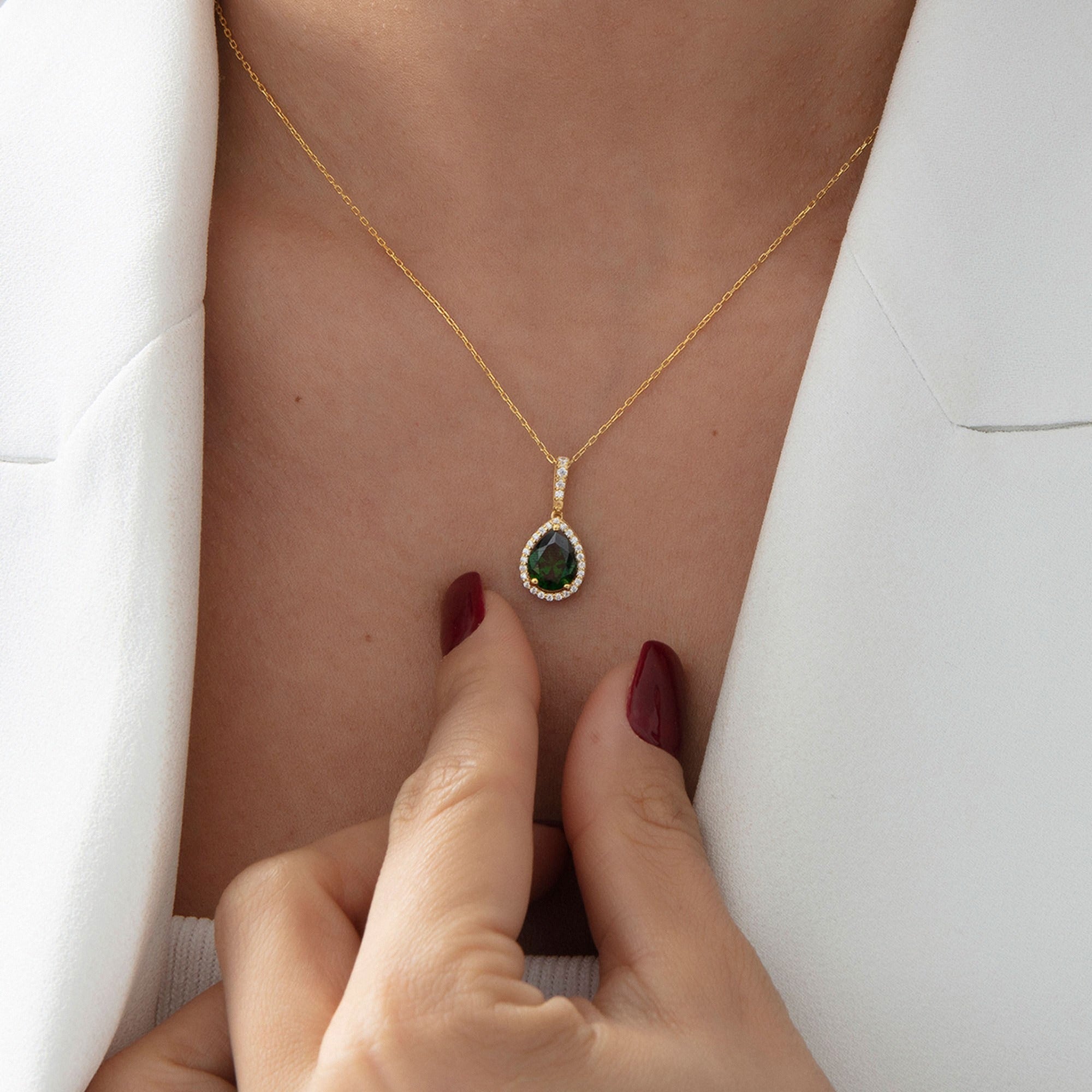 Pear Emerald Halo Necklace in gold, worn