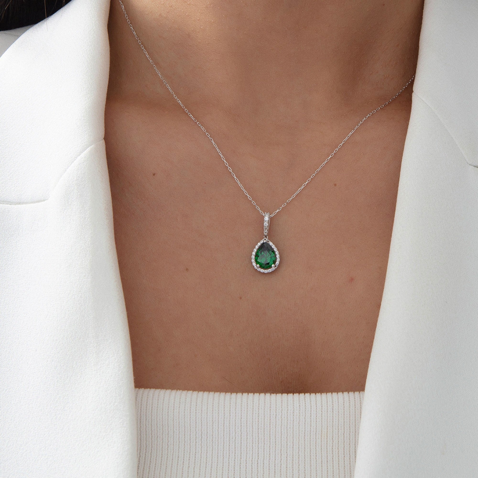 Pear Emerald Halo Necklace in silver, worn